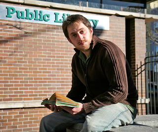 Even outdoors, Meyer can't seem to think of anything
better to do than flip through some American classic.